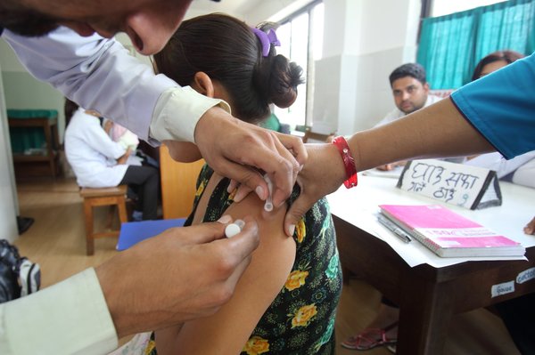 Sabina Rai receives a vaccination from Health Worker - Nepal_ Photo by Jim Holmes for AusAID.jpg